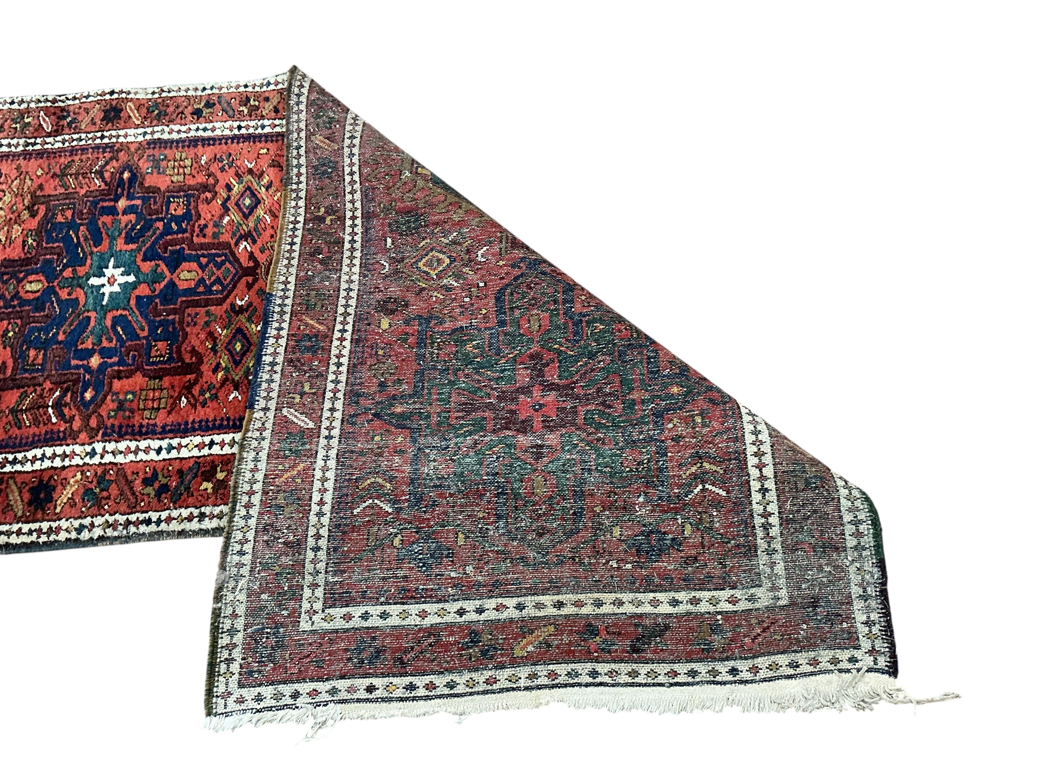A Karaja runner, the red field with six medallions, 335 x 82cm